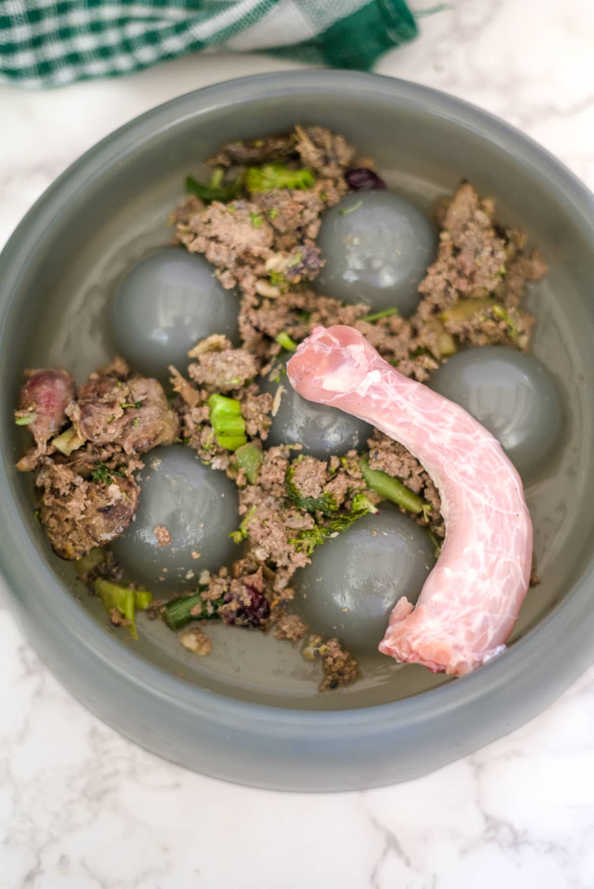 A bowl filled with meat and eggs.