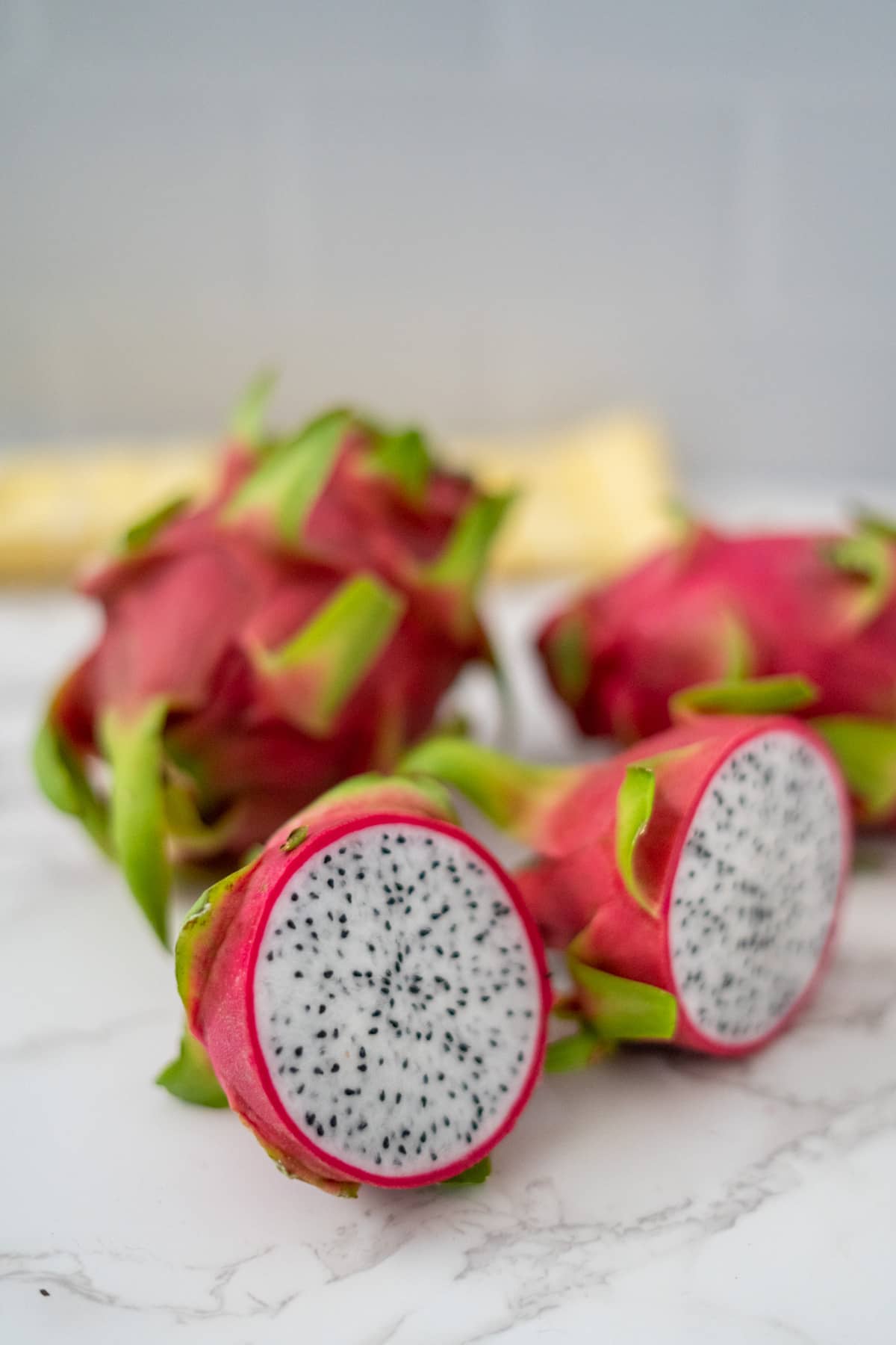 Dragon fruit on a white counter top.