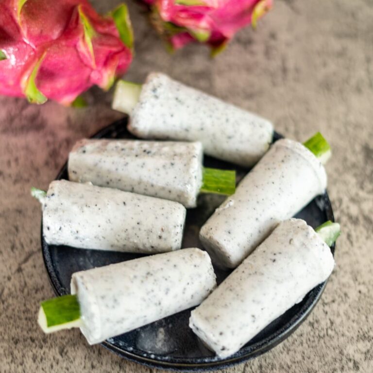 Dragon fruit rolls on a plate with pink flowers.