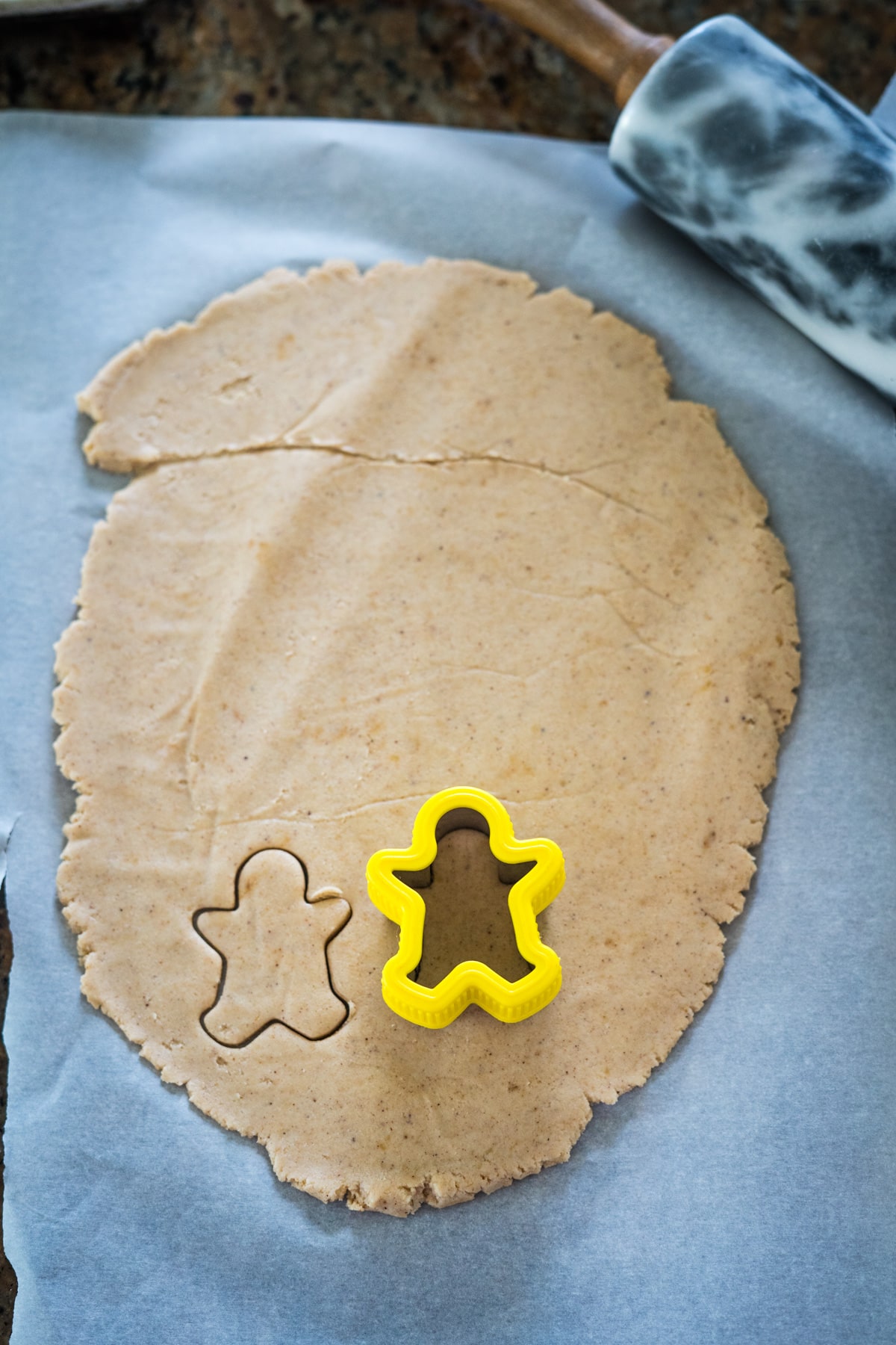 Gingerbread cookie cutters on a baking sheet.