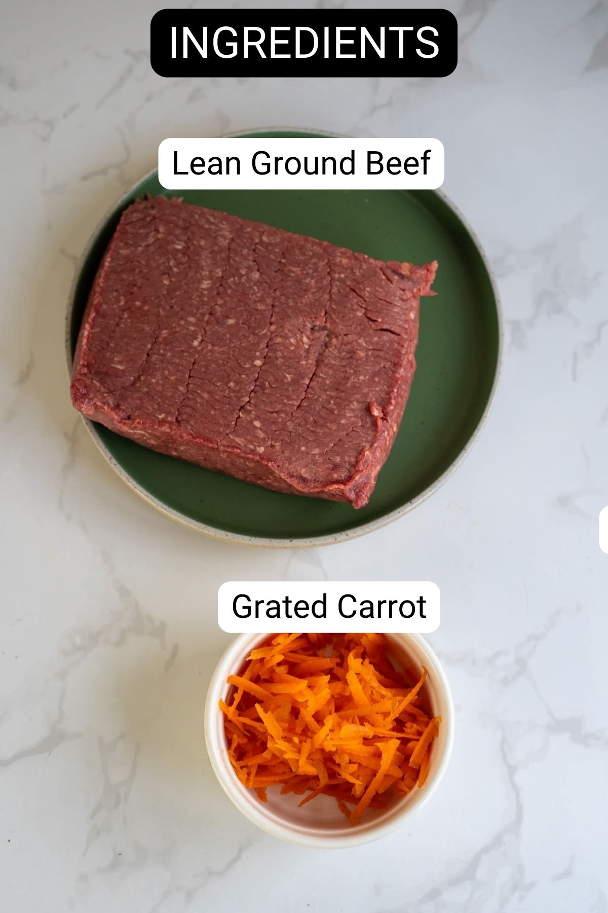 A plate with a block of lean ground beef and a bowl of grated carrot, both labeled as ingredients, on a white marble surface.