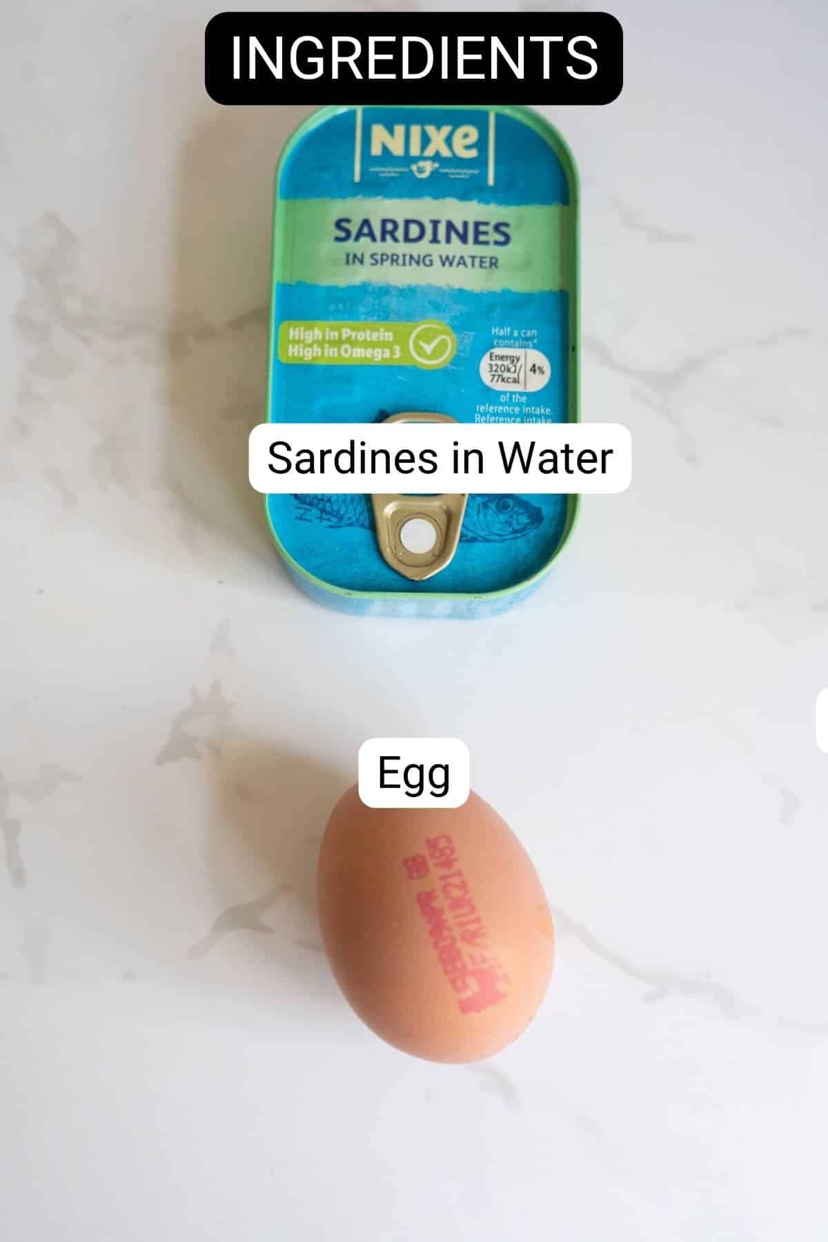 A tin of sardines in water and a brown egg on a white surface, labelled as ingredients.