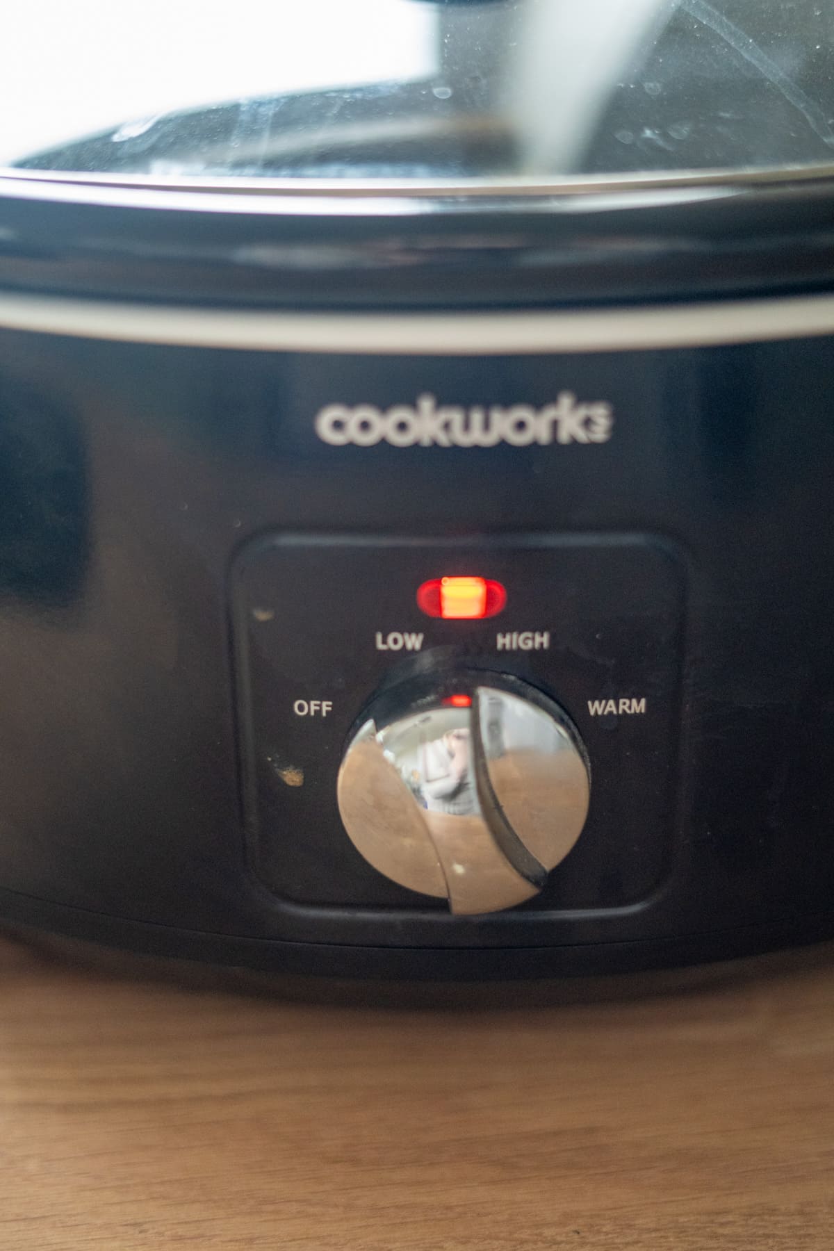 A close-up of a Cookworks slow cooker set to high, with the red indicator light on and settings labelled off, low, high, and warm—perfect for preparing slow cooker dog food.