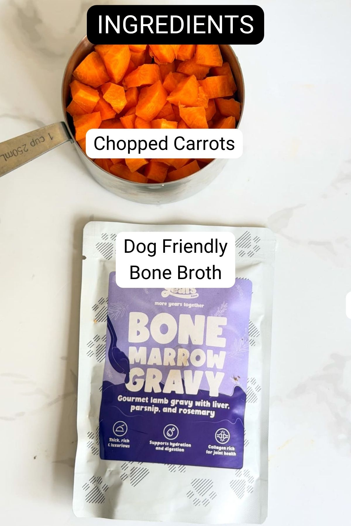 A measuring jug of chopped carrots and a packet of carrot bone broth dog treats gravy are shown on a white surface.