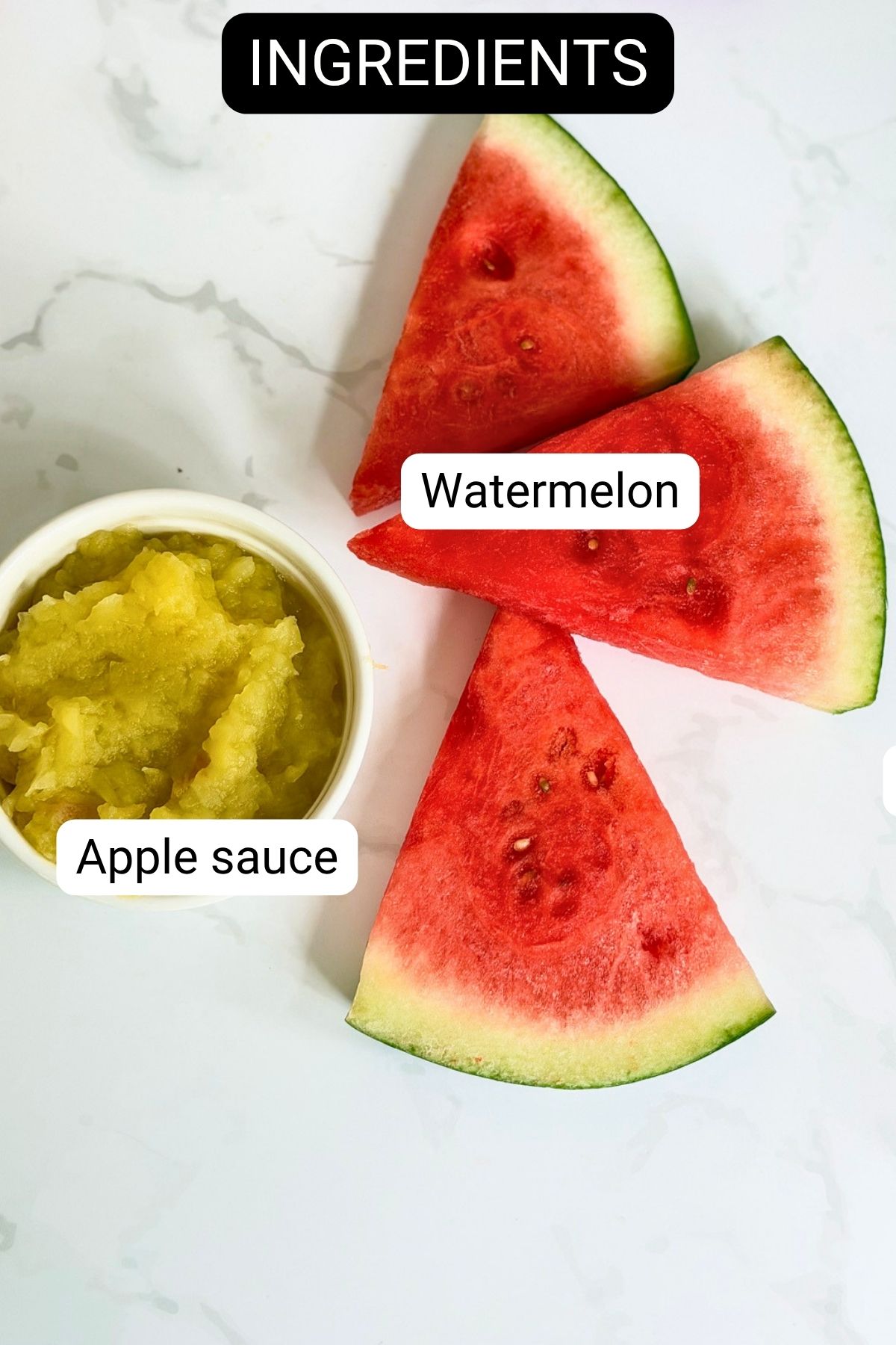 Three slices of watermelon and a small bowl of apple sauce are arranged on a white surface, each labelled with text.