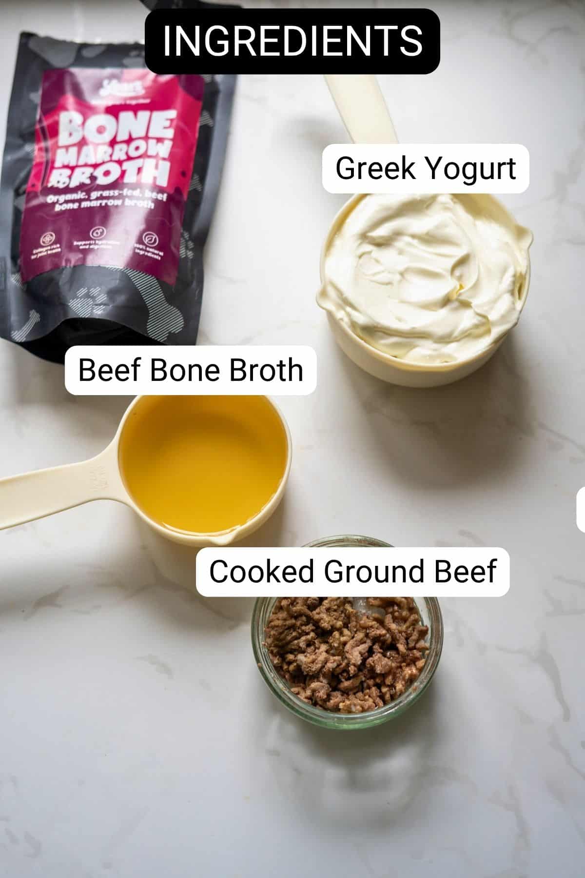 Labelled ingredients on a counter: a packet of bone marrow broth, a bowl of Greek yoghurt, a cup of beef bone broth, and a jar of cooked minced beef.