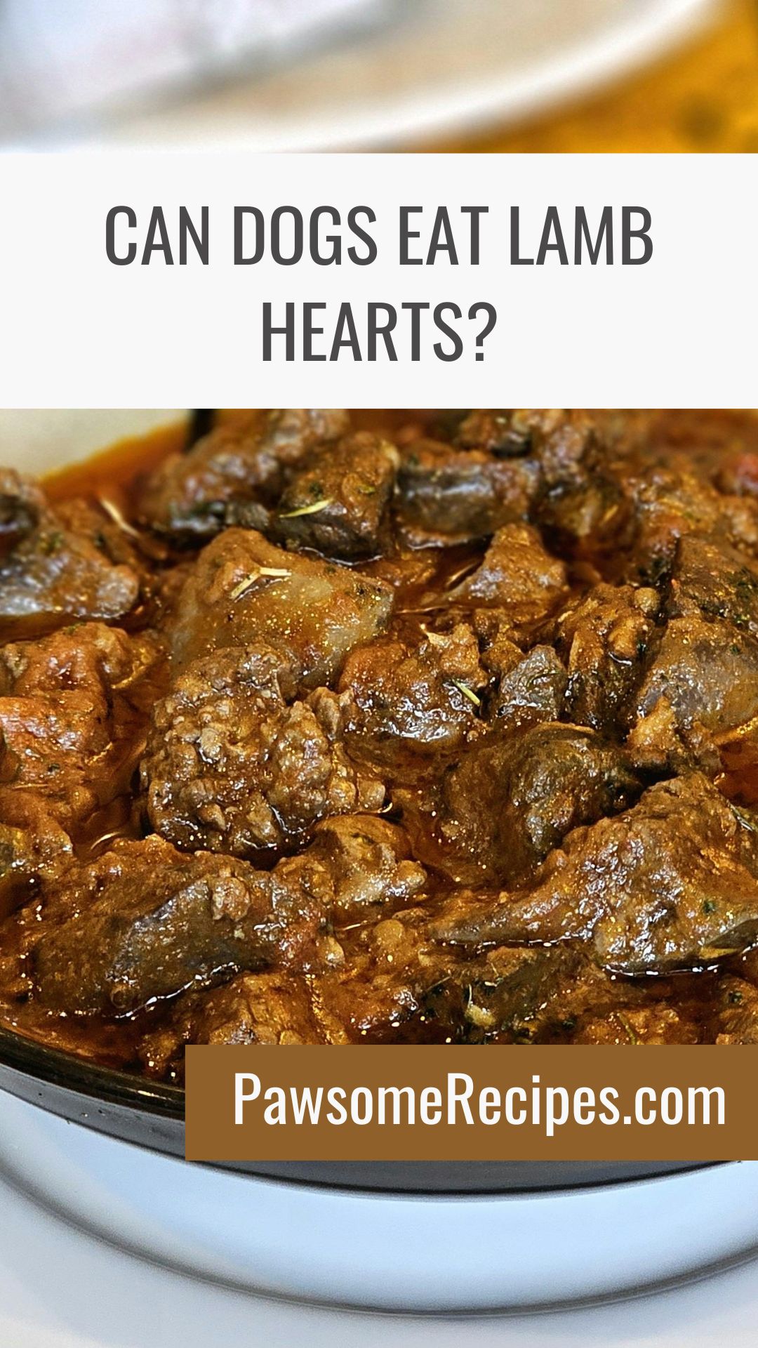 A close-up of cooked lamb hearts in a brown sauce, with text asking if dogs can eat lamb hearts and a website link, PawsomeRecipes.com.