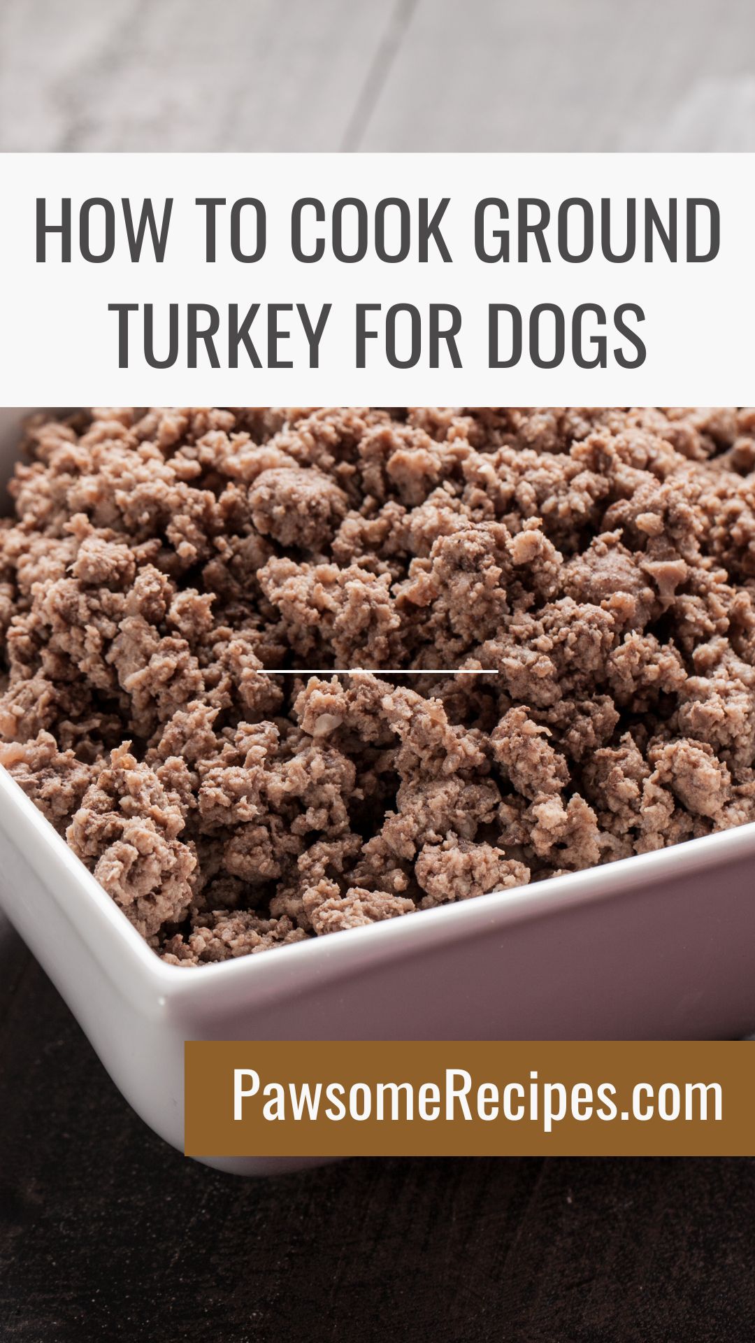 A white dish filled with cooked minced turkey sits on a dark surface. This image advertises a helpful guide on how to cook minced turkey for dogs, brought to you by PawsomeRecipes.com.