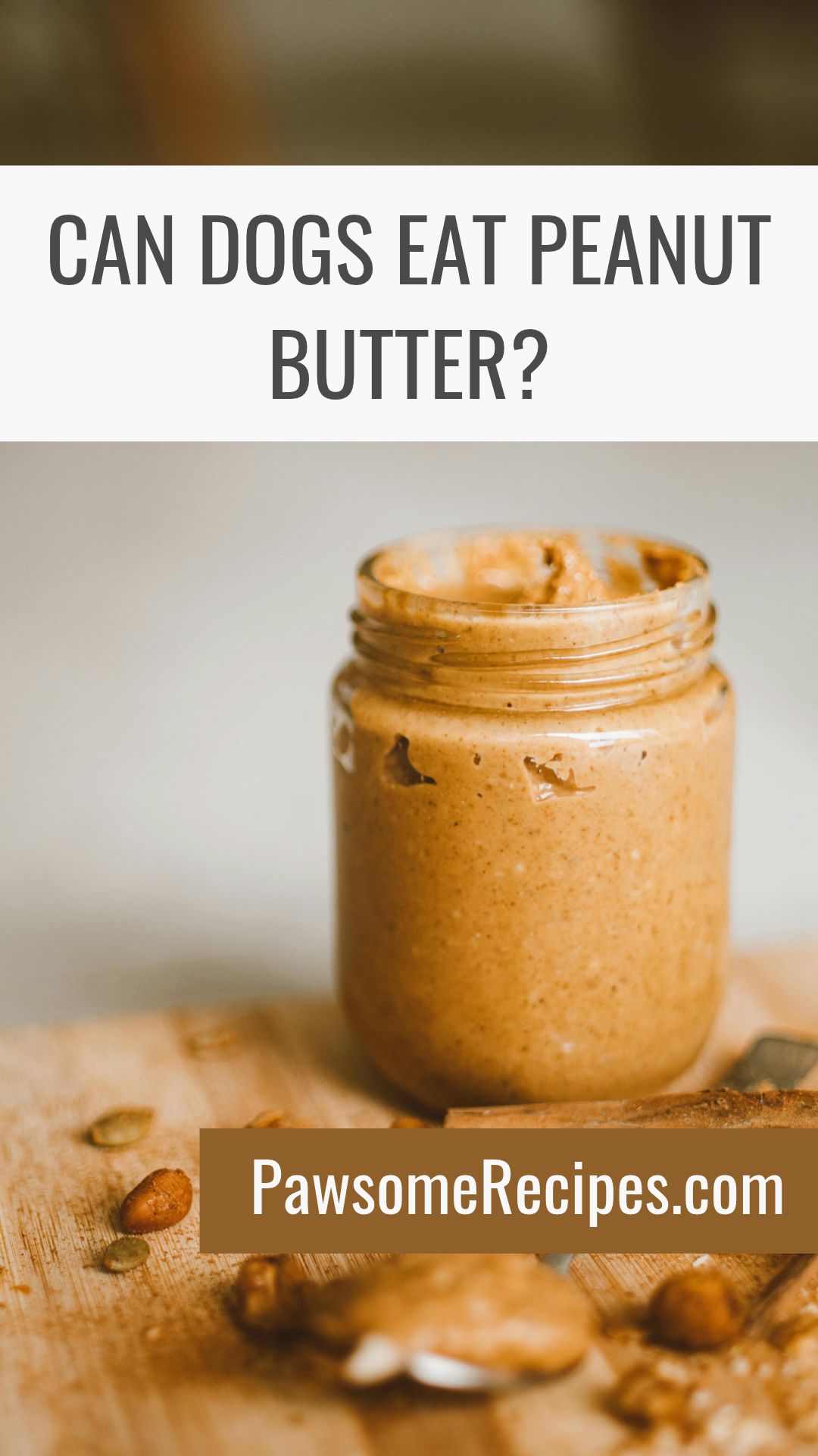 A jar of peanut butter on a wooden surface with text asking “Can dogs eat peanut butter?” and the website PawsomeRecipes.co.uk.